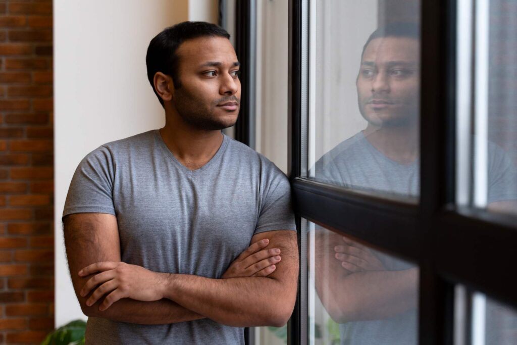 person guckt aus fenster